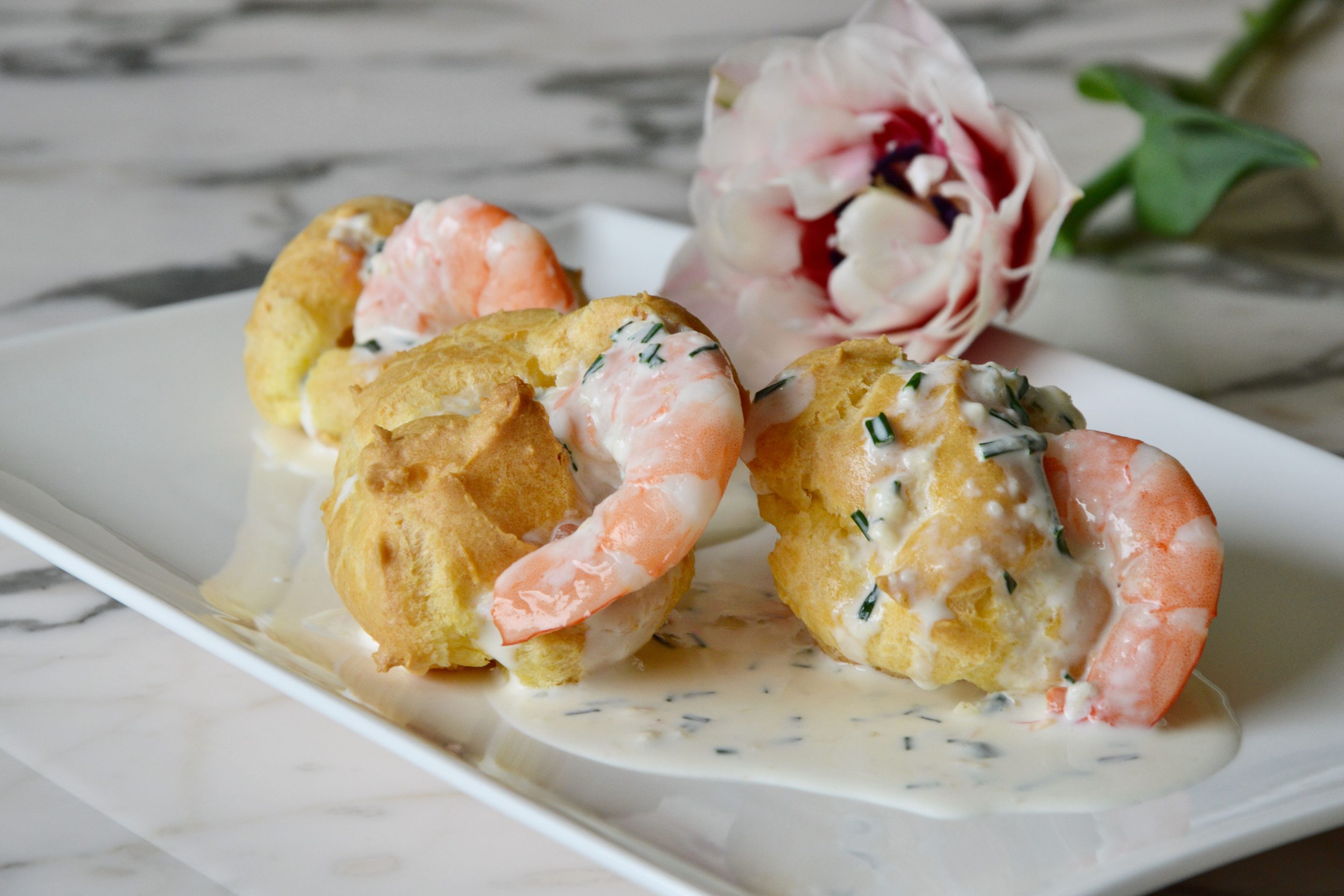 Shrimp profiterole with pastis and garlic cream