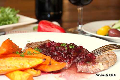 Sirloin with onion-pomegranate-and-berry sauce, served with orange sweet potato wedges. -