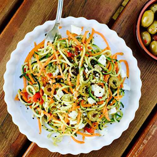 Vegetarian pesto courgette n' carrot noodles with feta cheese and olives