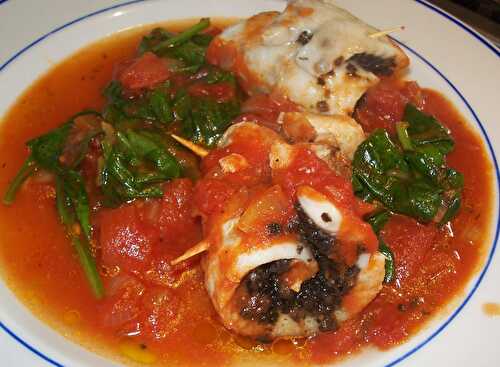 Rolled up fish stuffed with olives in a tomato and spinach sauce