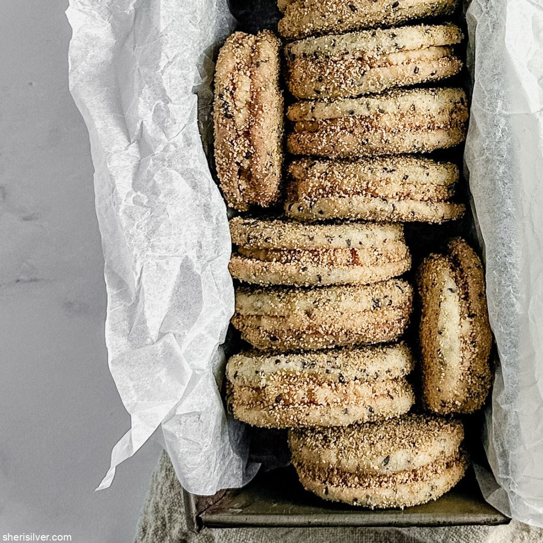 Sesame shortbread sandwich cookies with tahini frosting