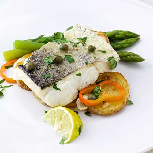 Hake served on roasted potatoes and asparagus